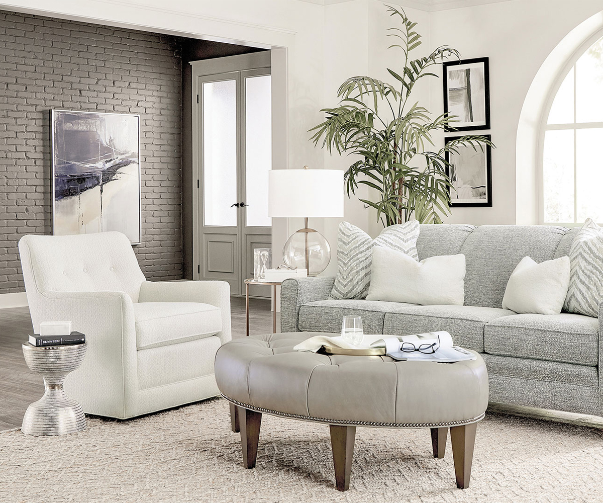 Sofas & chairs with gray sofa, white chair, and upholstered ottoman in a bright room.