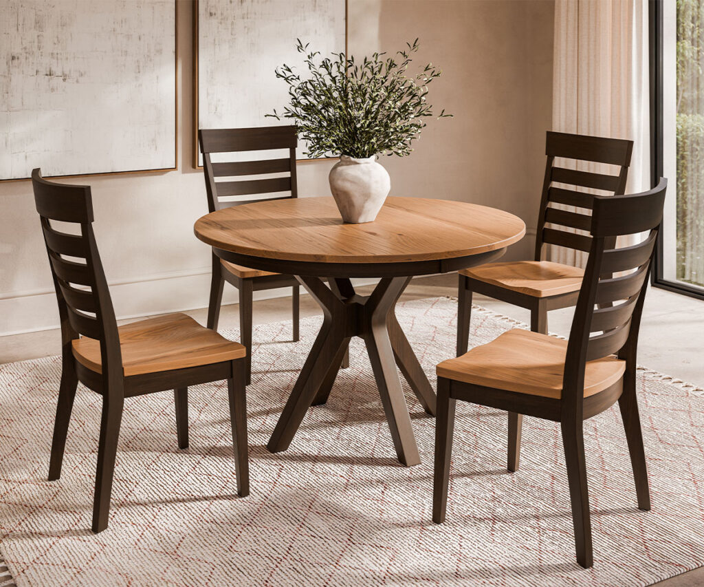 Dining room furniture with round wood table and four slat-back chairs in a warm setting.